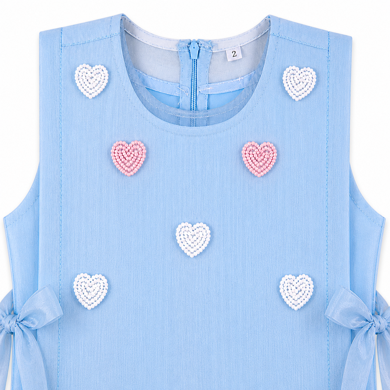 Light blue sleeveless dress with heart-shaped decorations on a white background