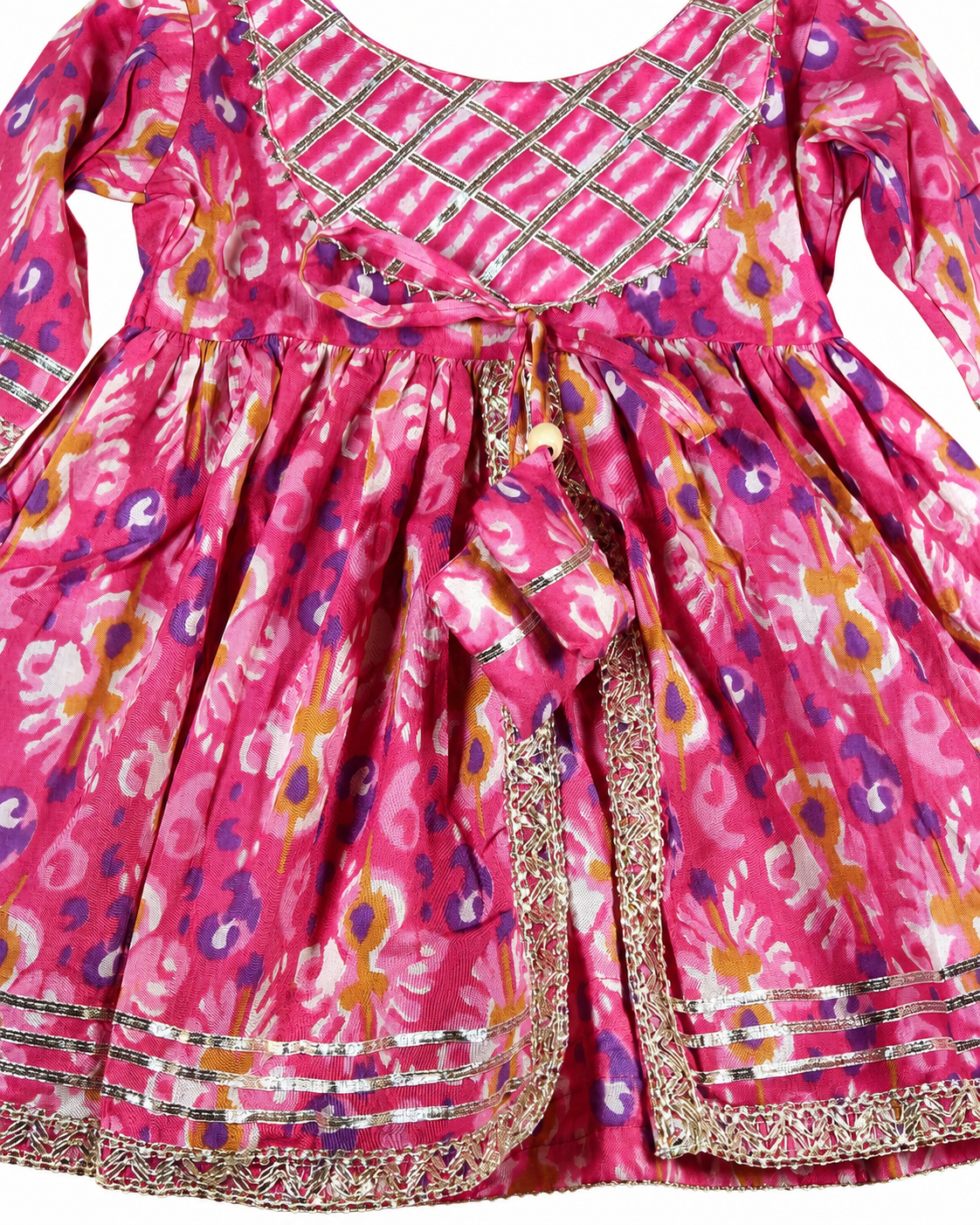 Pink children's dress with floral pattern and decorative elements on a plain background