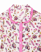 Children's pajama top with beach-themed print on a white background