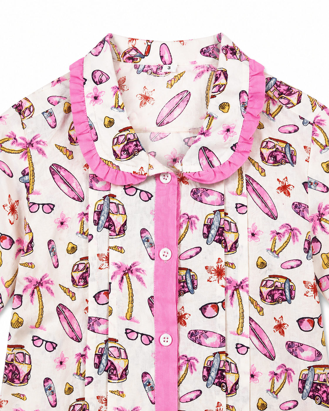 Children's pajama top with beach-themed print on a white background