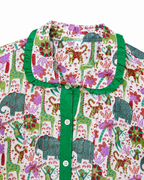 Children's shirt with colorful animal pattern and green collar on a white background
