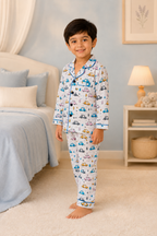 Child wearing pajamas with vehicle pattern in a bedroom setting