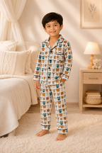 Child wearing pajamas with a cat pattern in a bedroom setting