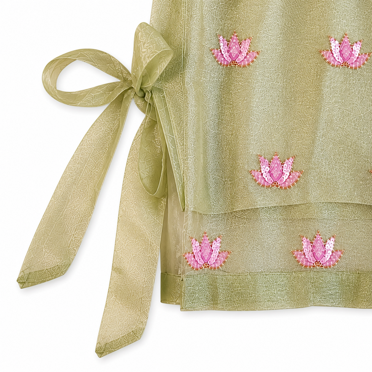 Green fabric with pink floral embroidery and a ribbon on a white background