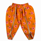 Orange pants with floral pattern and gold accents on a white background