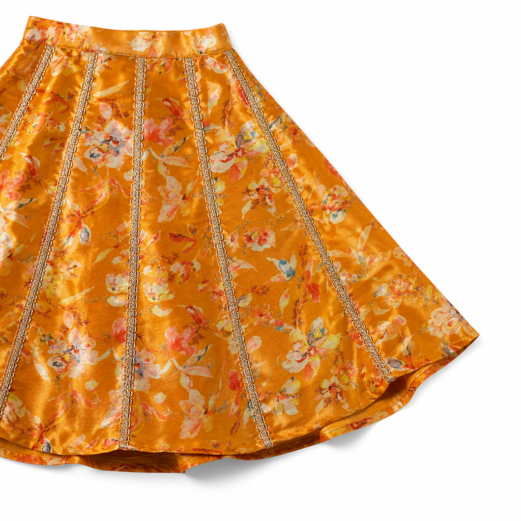 Orange floral skirt with decorative trim on a white background