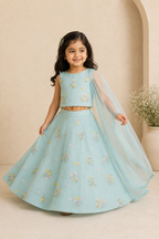 Young girl in a light blue embroidered traditional outfit with a beige background