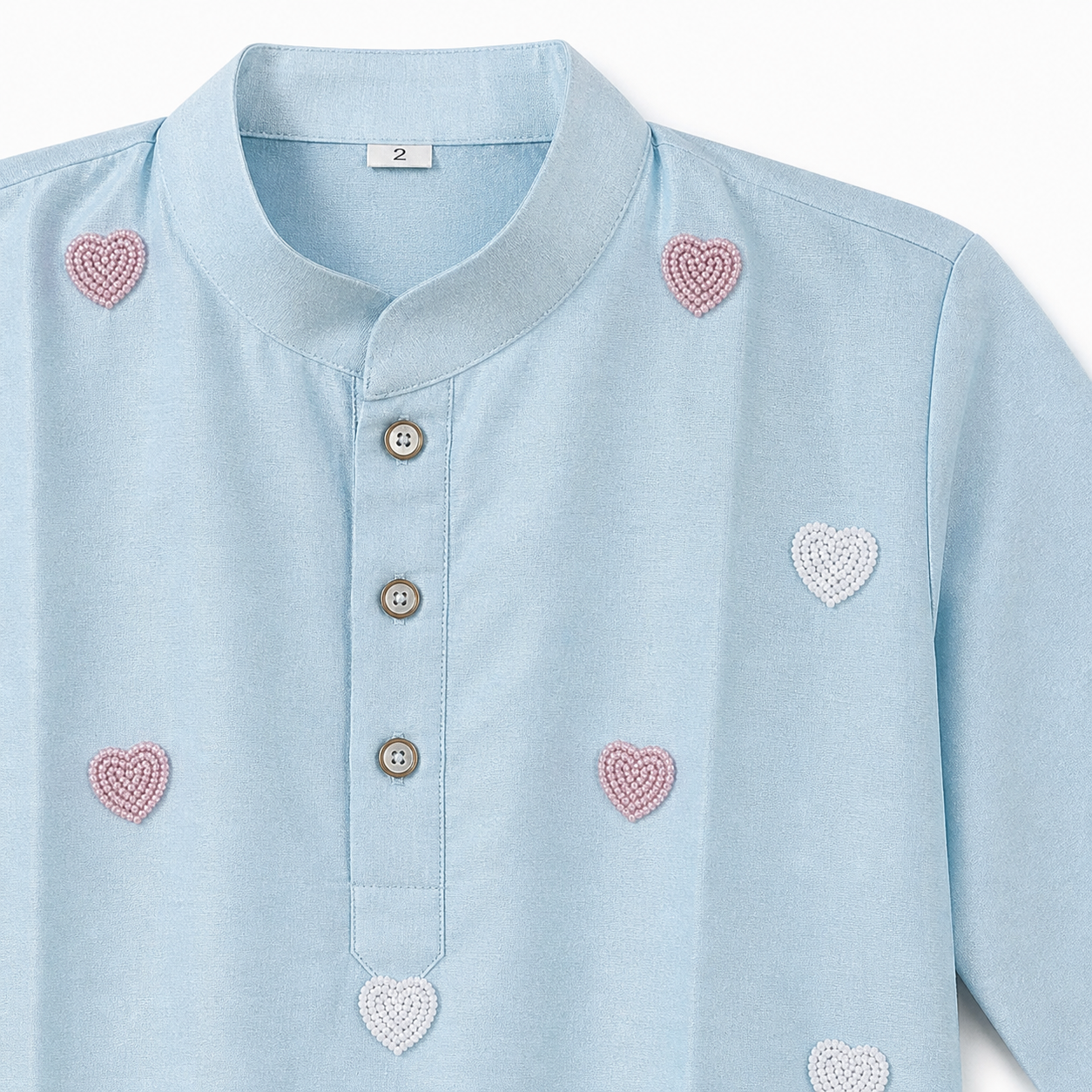 Light blue shirt with heart patterns on a white background