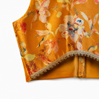 Floral patterned fabric with gold trim on a white background