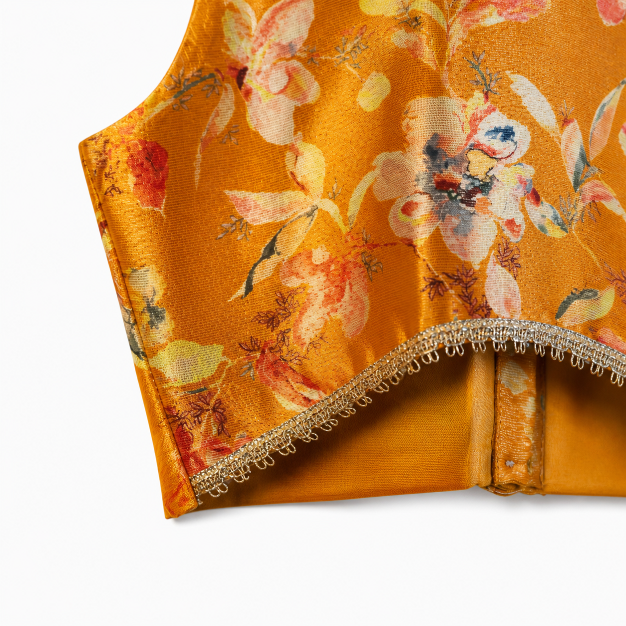Floral patterned fabric with gold trim on a white background