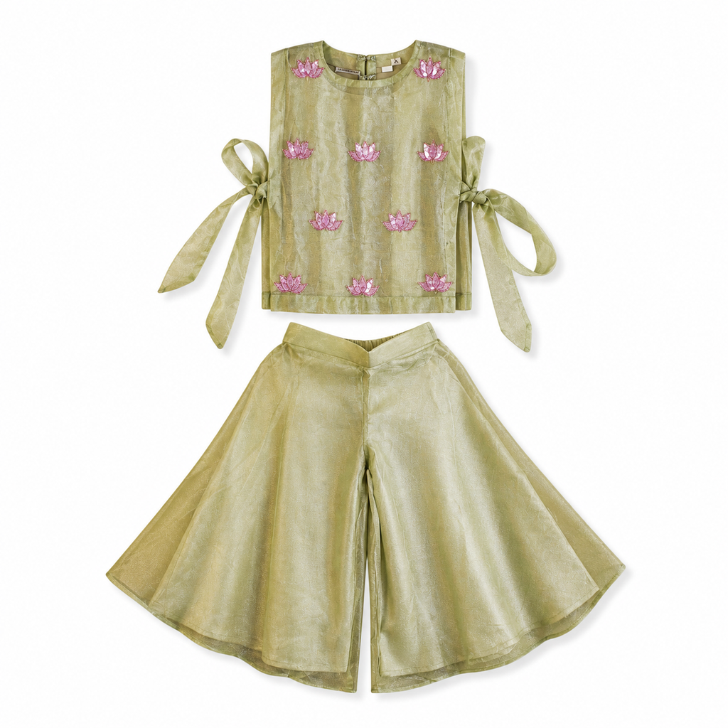 Green outfit with pink floral embroidery on a white background