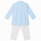Light blue shirt and white pants on a white background