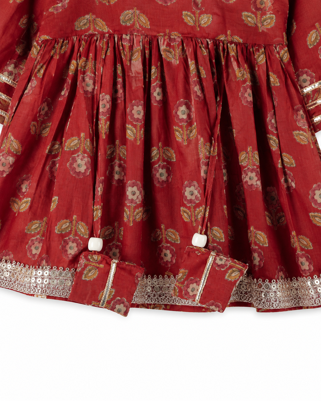 Red dress with gold floral pattern on a white background