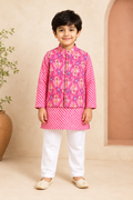 Child wearing a pink floral jacket and white pants in a neutral setting