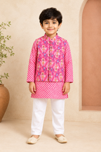 Child wearing a pink floral jacket and white pants in a neutral setting