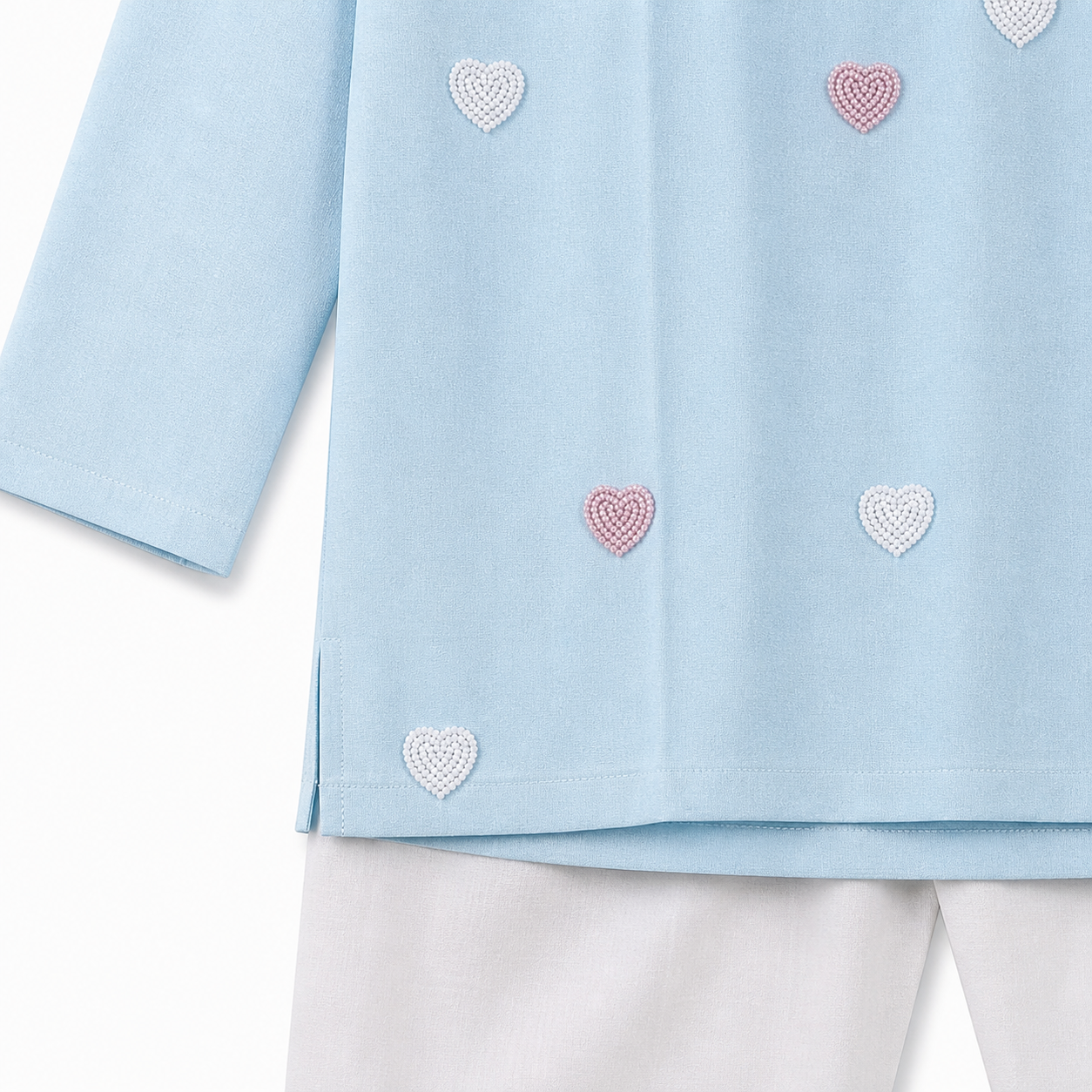 Light blue top with heart patterns on a white background