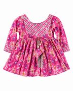 Pink floral dress with decorative elements on a white background