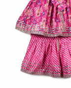 Pink traditional outfit with floral patterns on a white background