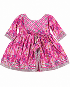 Pink floral dress with a patterned trim on a white background