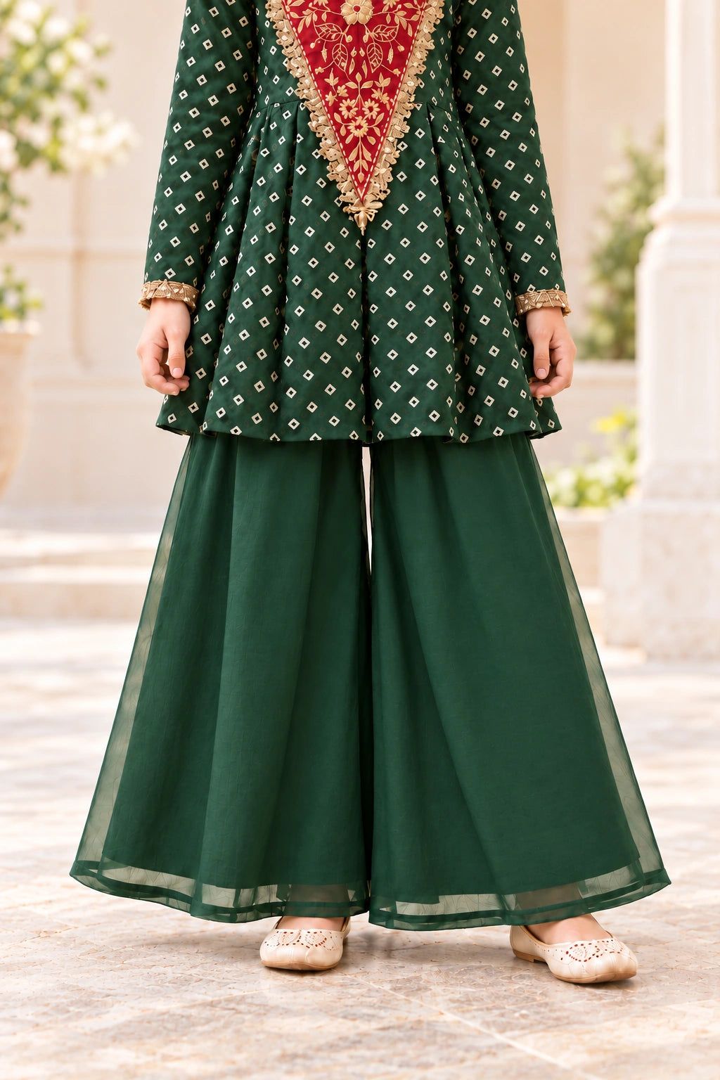 Bottle green wide-flared organza palazzo trousers showing their drape and narrow sheer hems