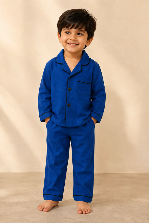 Boy wearing classic dark blue piped kids night suit, front view