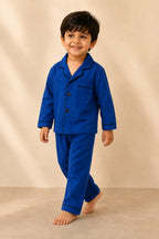 Boy wearing classic dark blue piped night suit in movement