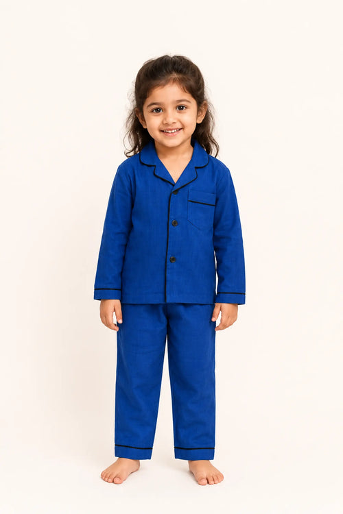 Girl wearing classic dark blue piped kids night suit, front view