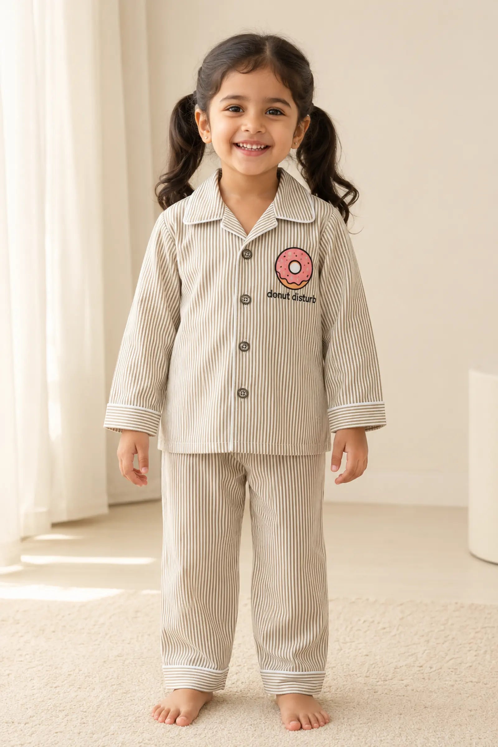 Girl wearing Donut Disturb striped kids night suit, front view