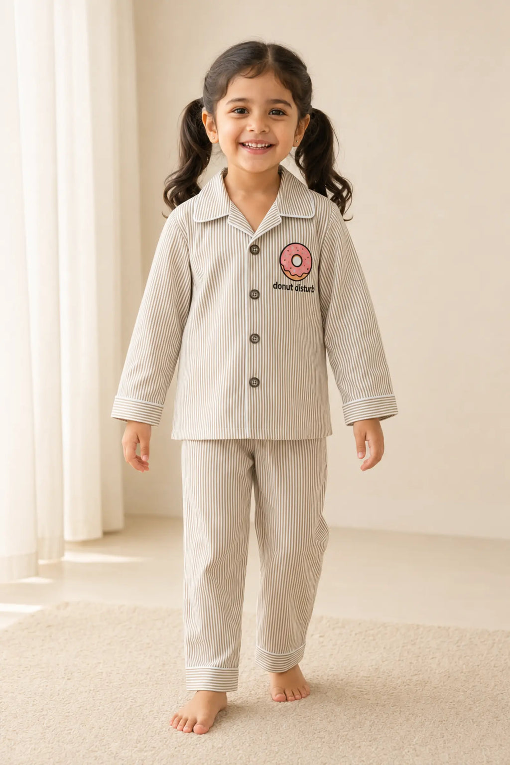 Girl wearing striped Donut Disturb night suit in three-quarter view