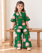 Emerald Green Floral Angrakha Palazzo Set for Girls — seated lifestyle view