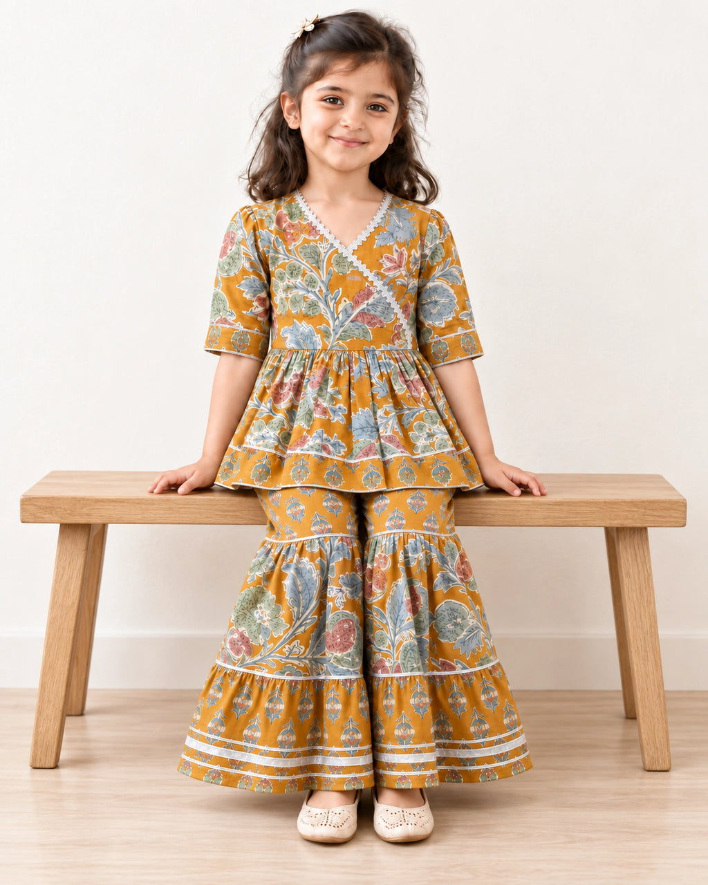 Mustard Floral Peplum Sharara Set for Girls — seated lifestyle view