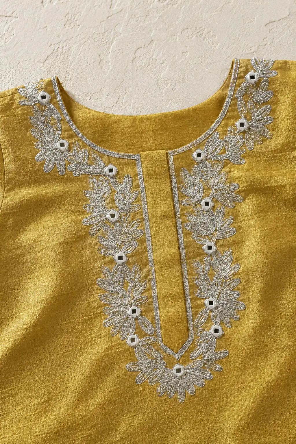 Close-up of mirror and gota handwork around the round neckline