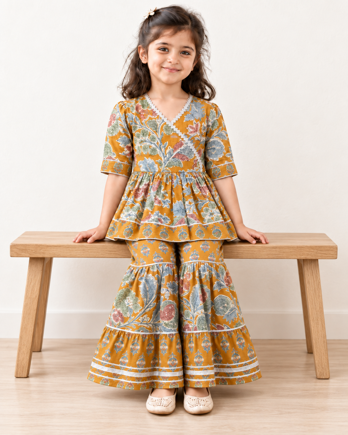 Mustard Floral Peplum Sharara Set for Girls — seated lifestyle view