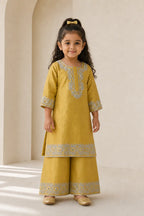 Girl in mustard kurta and flared pants, alternate front view