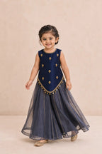 Girl walking in navy blue Indo-Western top and dusty navy sharara, movement view
