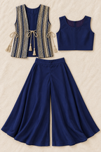Flat lay showing the separate plain cropped blouse, gold-detail tie-up jacket and navy palazzo trousers