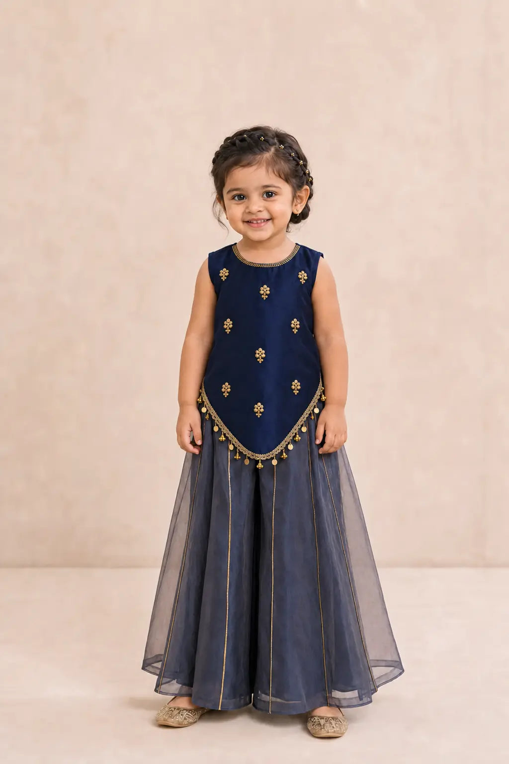 Girl wearing navy blue zardosi and cutdana top with dusty navy sharara, front view