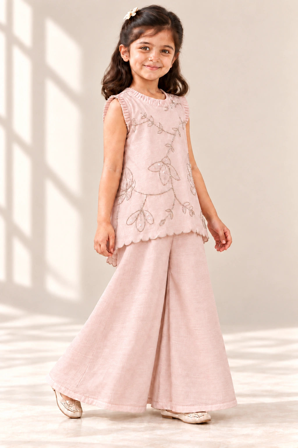 Nude pink girls top and palazzo set with floral pita work, three-quarter view