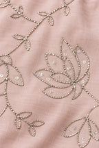 Close-up of flattened metallic floral pita work and small sequins on nude pink mulmul fabric