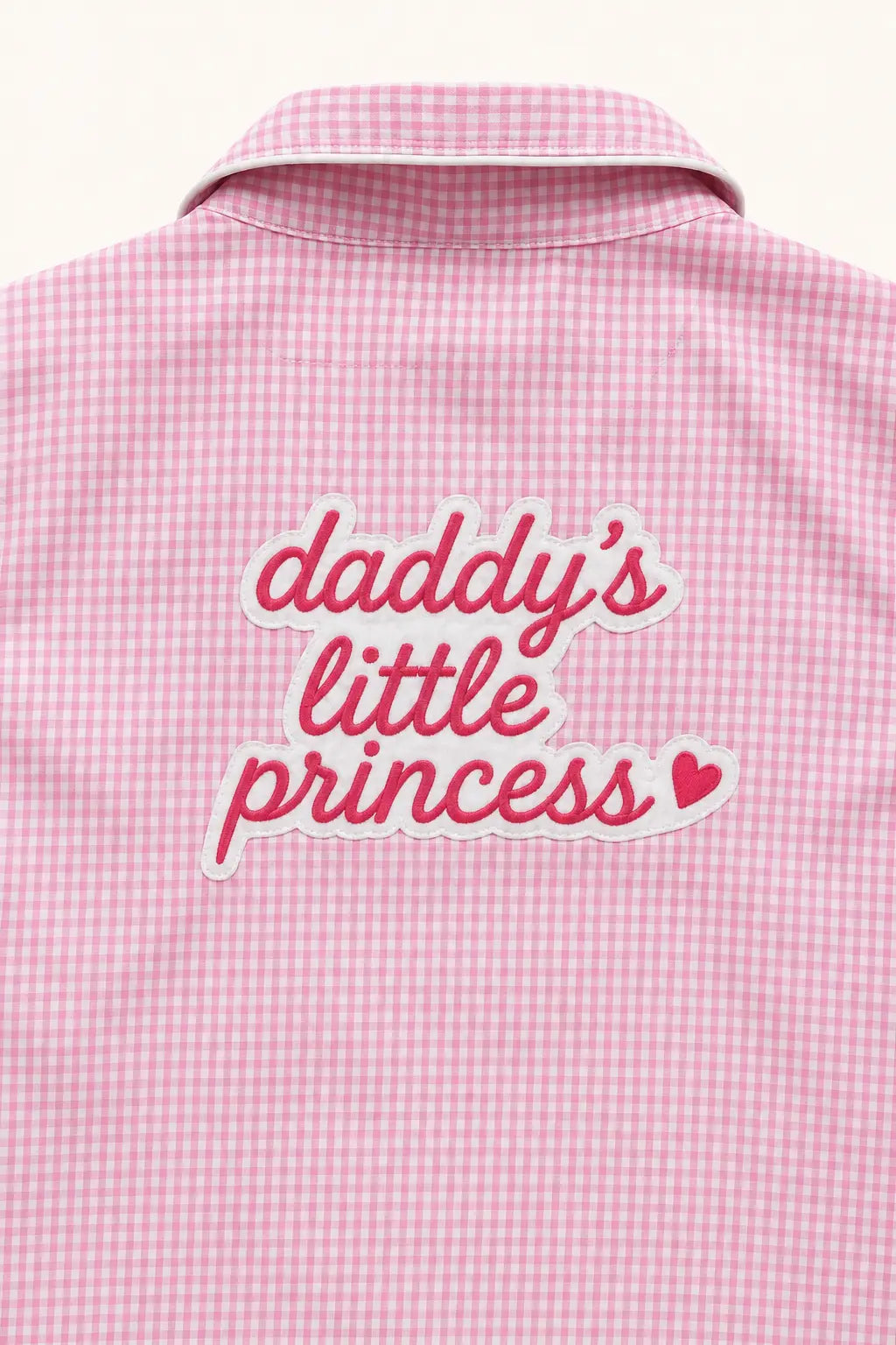 Close-up of Daddy's Little Princess print on pink gingham shirt