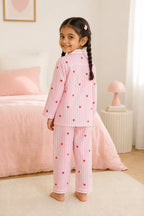 Girl wearing pink striped heart print night suit, back view