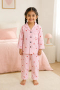 Girl wearing pink striped heart print night suit, front view