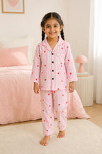 Girl wearing pink striped heart print night suit while walking