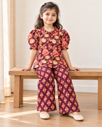 Plum Floral Puff-Sleeve Palazzo Set for Girls — seated lifestyle view