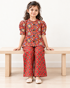 Red Floral Puff-Sleeve Palazzo Set for Girls — seated lifestyle view