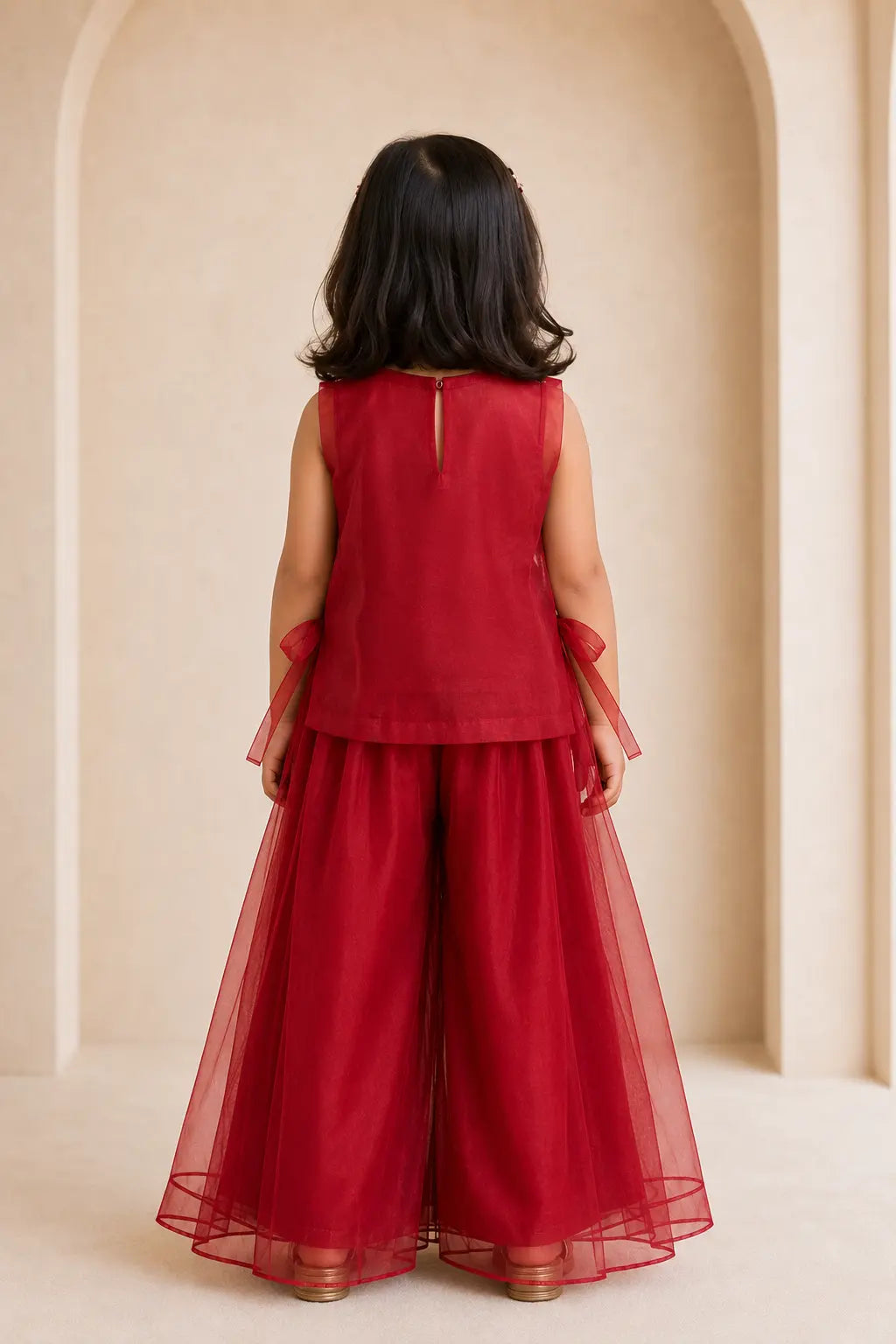 Back view of girl in ruby red organza top and palazzo set