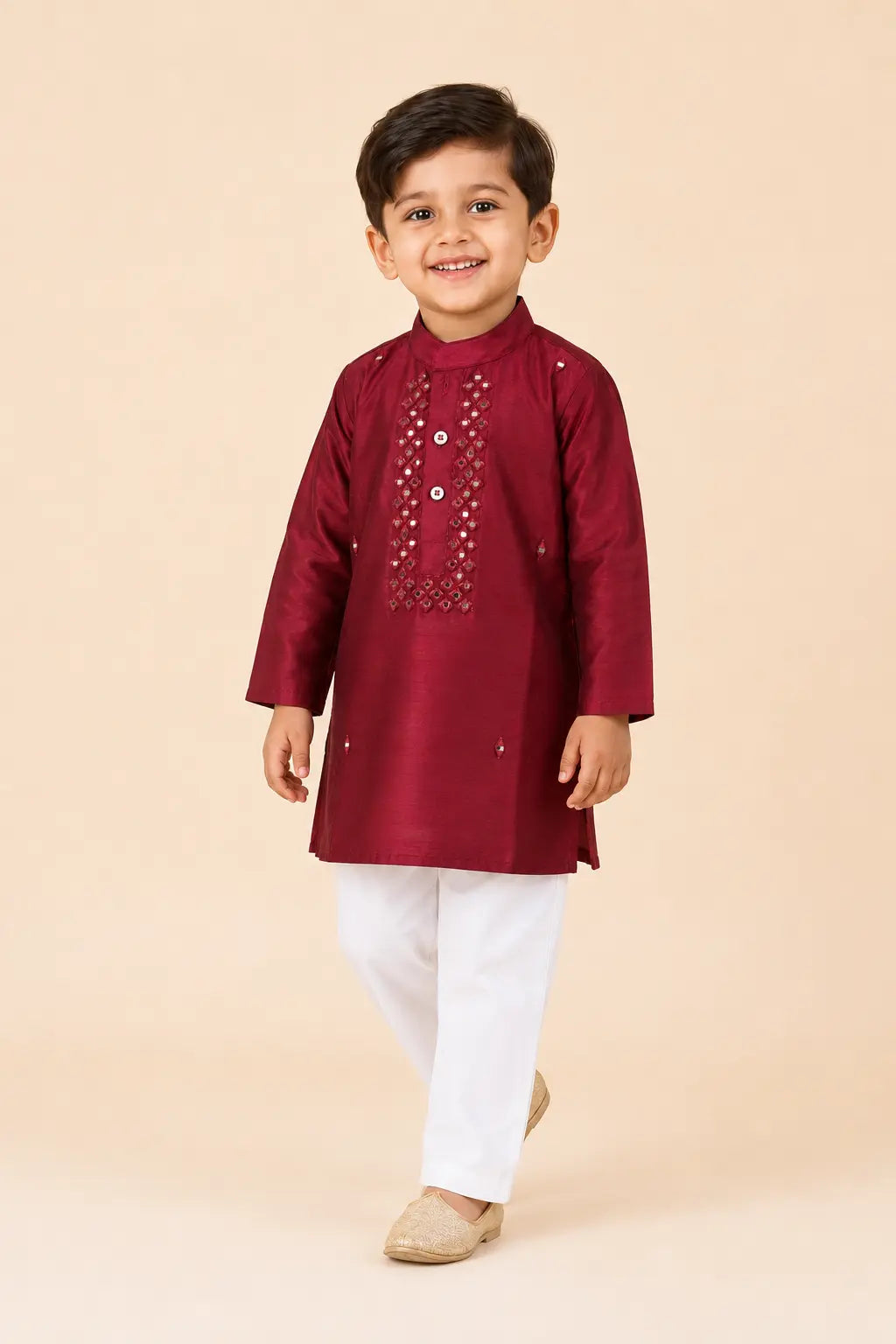 Boy wearing ruby red embellished kurta with classic white pants, front view