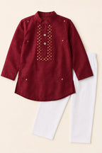 Ruby red candy silk kurta and classic white pants laid flat