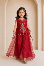 Girl walking in ruby red cutdana organza top and palazzo set, movement view