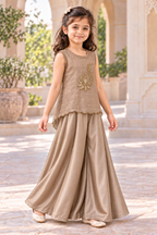 Three-quarter view of the sleeveless taupe gold handwork top and wide-flared satin palazzos